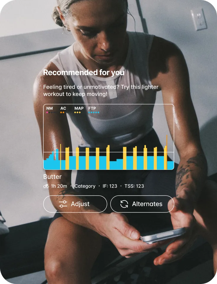 An athlete reviewing their recommended session on a tablet at an indoor trainer setup